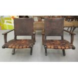 A pair of mid 20thC stained beech framed, folding, open arm chairs with decoratively tooled hide