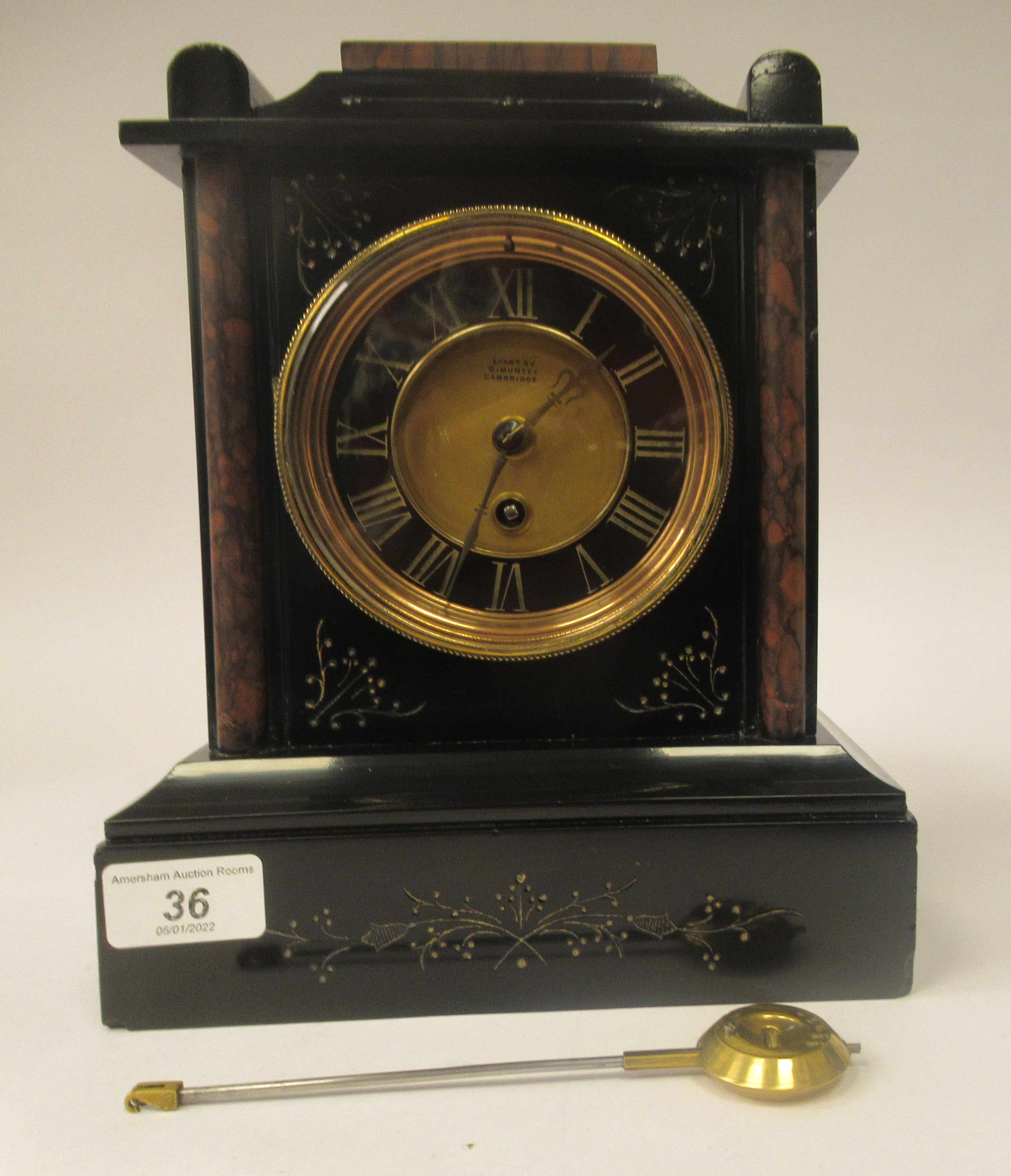 A late 19thC black slate and mottled iron red marble cased mantel timepiece with a platform top; the