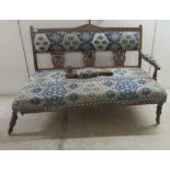 An Edwardian mahogany showwood framed three person settee, the later stylised patterned fabric