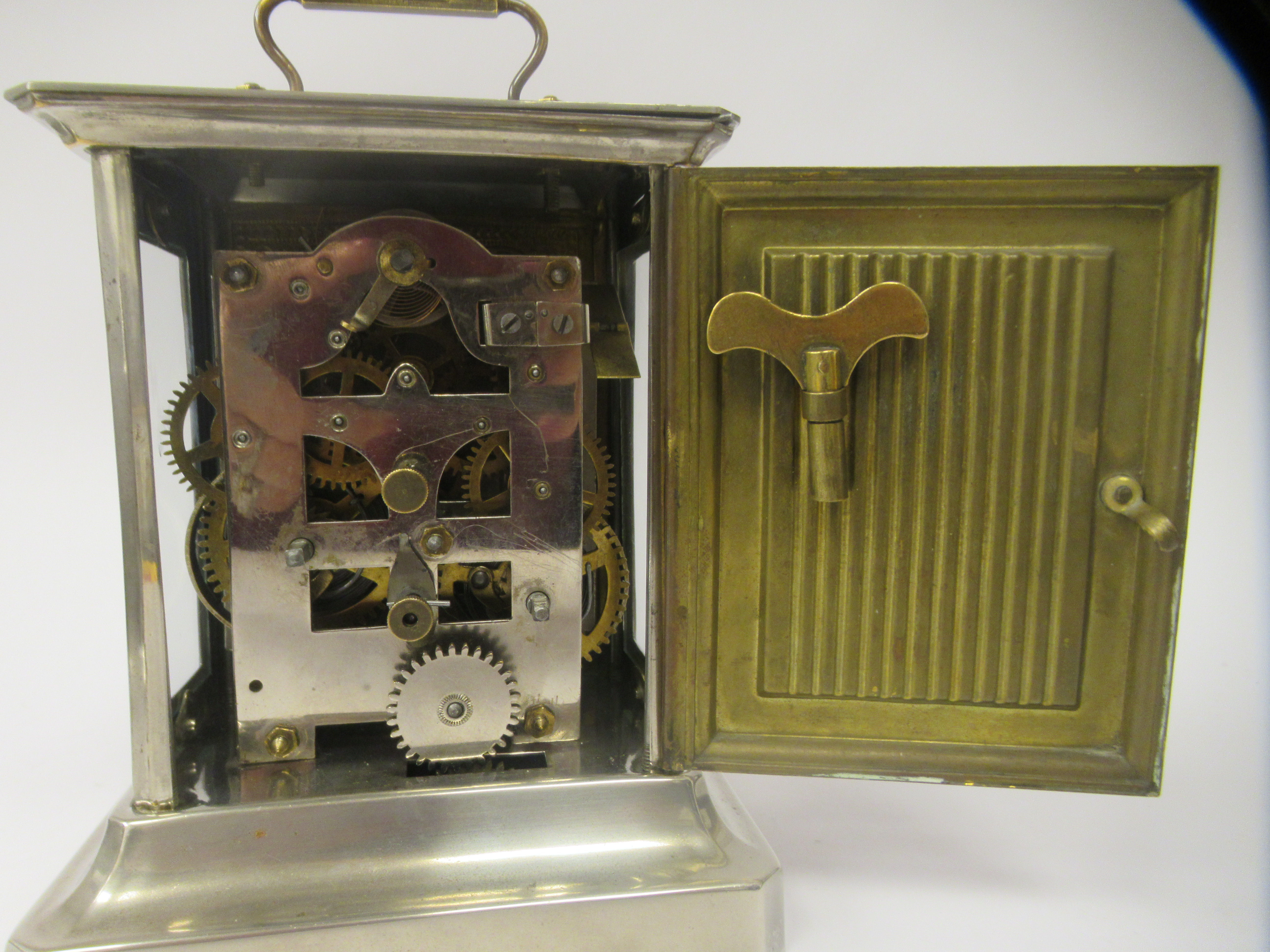 An early 20thC electroplated and brass inlaid mantel clock with a glazed panel and a folding top - Image 4 of 6