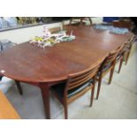 A 1960s/70s Danish teak dining table, the top with a crossbanded border, raised on square, tapered