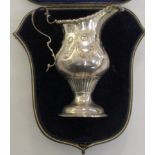 A late Victorian silver cream jug bearing maker's initials WC/JC, in a Goldsmiths & Silversmiths