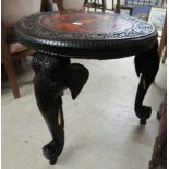 A modern Asian hardwood occasional table, the top decorated with a figure, camels and elephants