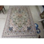 A Persian design rug, profusely decorated with flora and foliage, on a cream coloured ground  65"