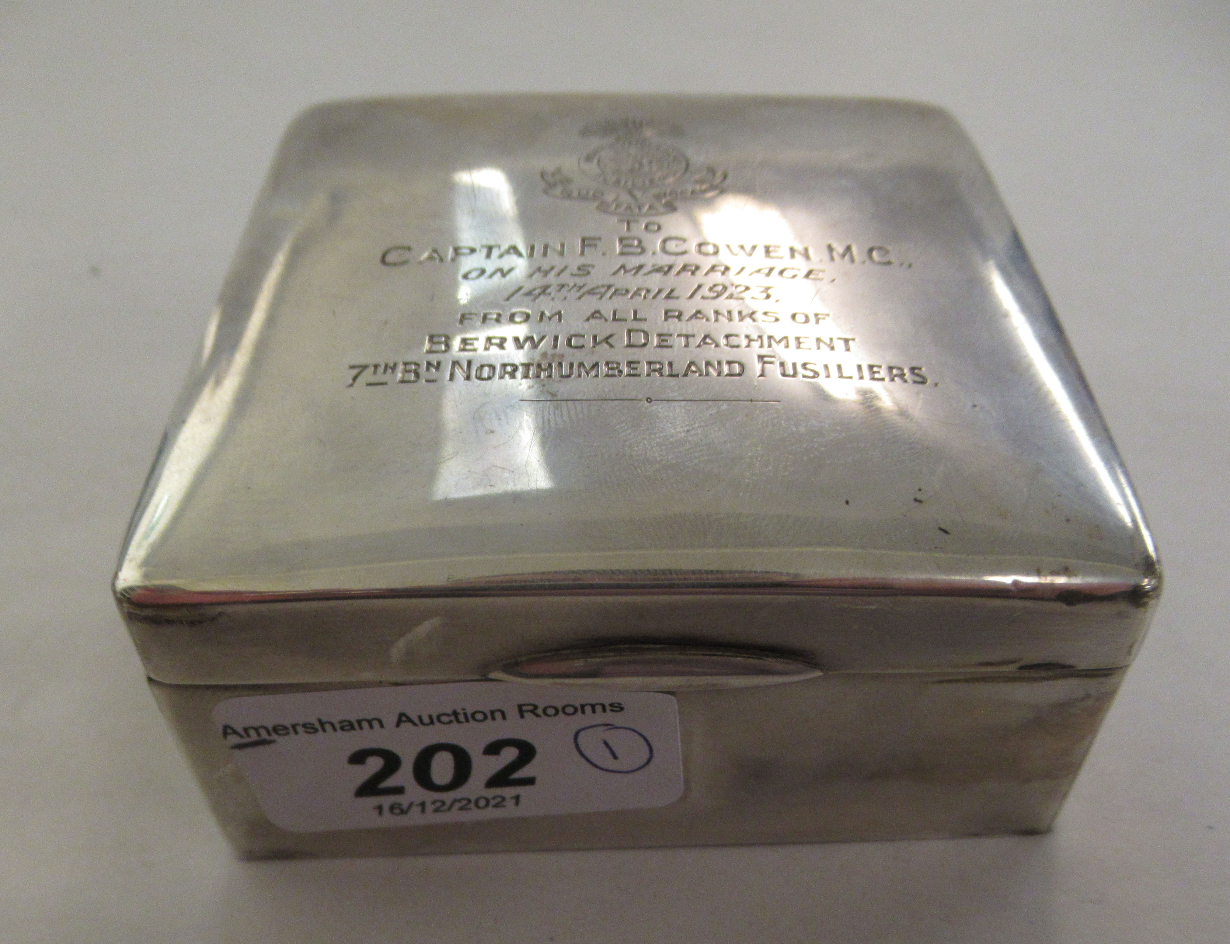 A silver cigarette case, the hinged lid inscribed 'Northumberland Fusiliers Captain F B Cowen MC'