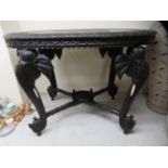 A modern Asian hardwood occasional table, the oval top decorated with a figure and two elephants,