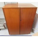 A 1960s/70s Home Office teak compactum style desk, the double open front enclosing a fitted interior