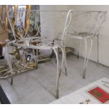 A pair of white painted wrought metal terrace chairs