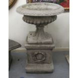 A composition stone terrace pedestal urn with egg and dart ornament, on a box plinth  40"h  26"dia