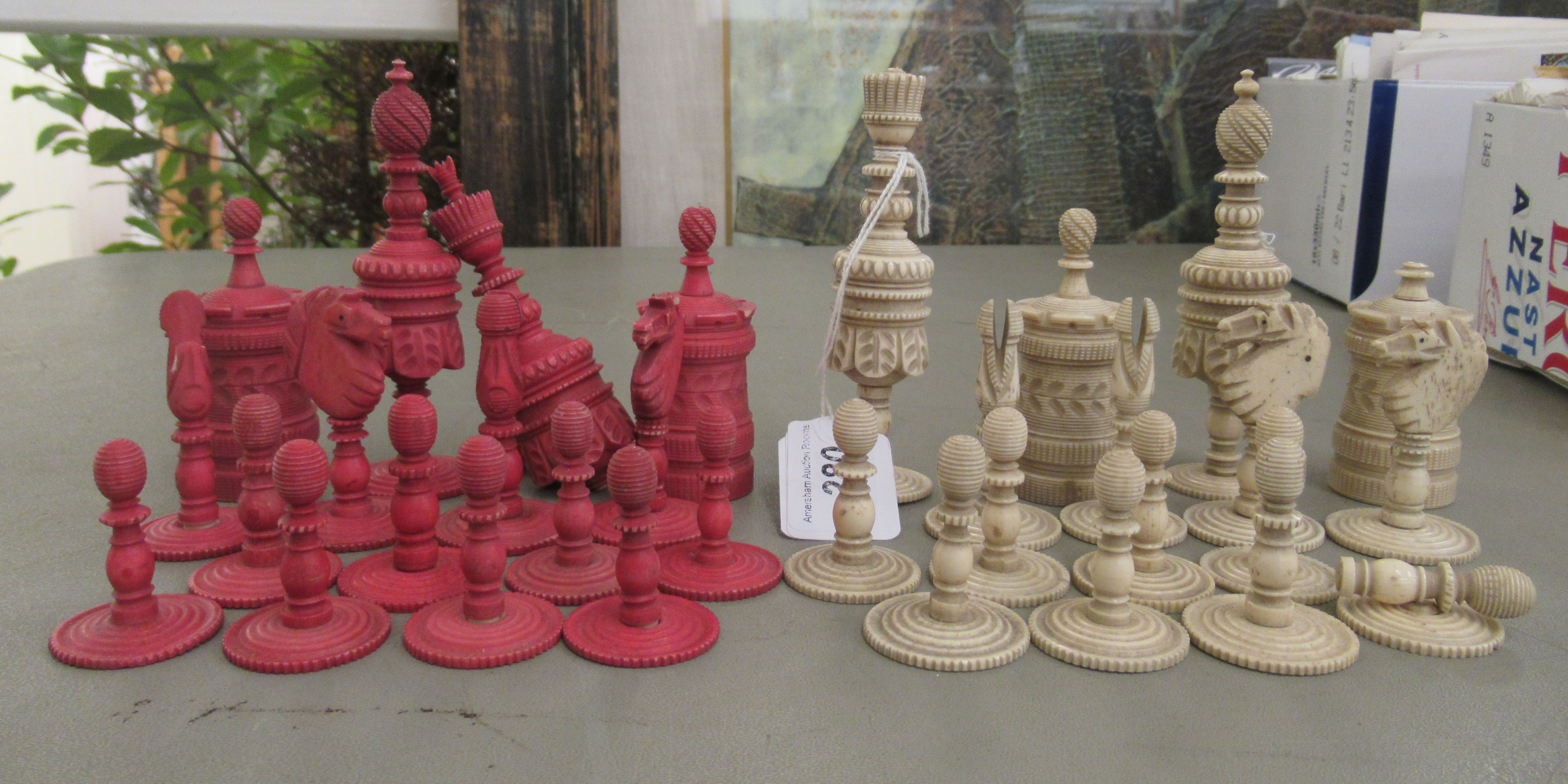 A late 19th/early 20thC carved and turned beetlenut stained and naturally coloured bone chess set
