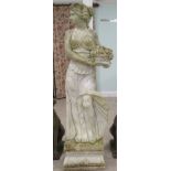 A carved marble terrace statue, a classically attired maiden holding flowers, on a plinth  63"h