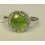 A platinum peridot and diamond set ring