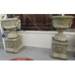 A pair of composition stone terrace pedestal urns with lion mask ornament, on box plinths  45"h