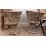 A pair of composition stone pedestal terrace urns with floral ornament  22"h  20"dia