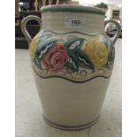 A Poole pottery (circa 1921-1934) twin handled vase with hand painted flora and wave patterns  bears