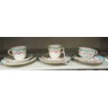 An Edwardian Copeland china trio, decorated with gilded ribbon and floral ornament, in pastel tones;