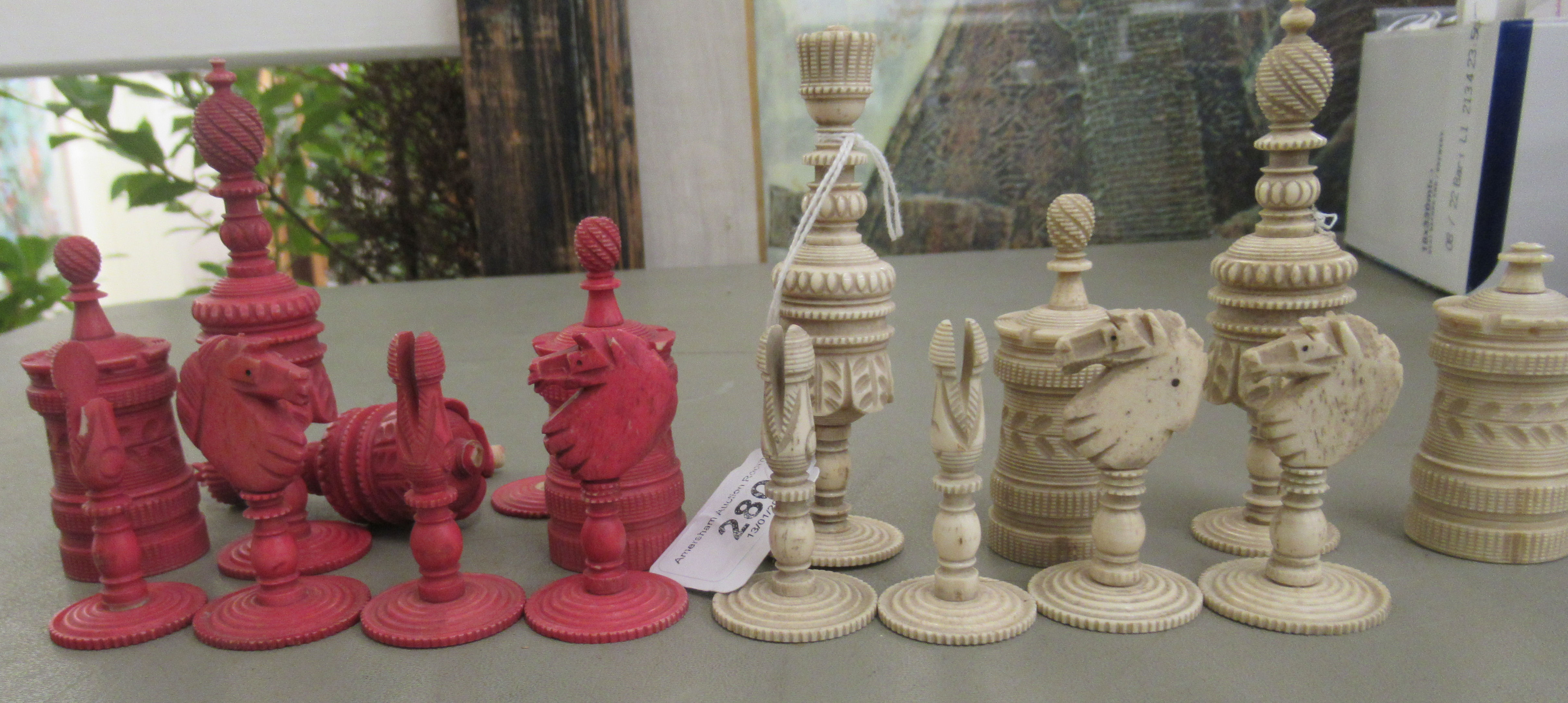 A late 19th/early 20thC carved and turned beetlenut stained and naturally coloured bone chess set - Image 2 of 3