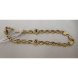 A gold coloured metal gate link bracelet, set with white and coloured stones  stamped 750