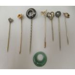 Seven yellow metal stick pins  variously mounted