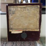 A replica of an antique handwritten document with a simulated wax, oversize seal, mounted on fabric