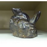 A cast and patinated bronze model, a frog on a rock  4"h