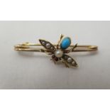 A yellow metal bar brooch, set with turquoise and peal, fashioned as a fly