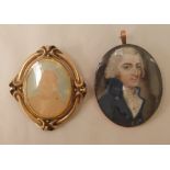 A 19thC gold coloured metal framed portrait miniature, a middle aged man, wearing smart attire;