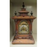 An early 20thC oak cased mantle clock; the Wurttemberg of Germany movement, faced by a Roman dial