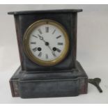 A 1930s black slate cased breakfront mantel clock; the movement faced by a Roman dial  9"h  8"w