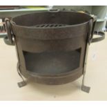 A cast metal table top charcoal cooking stove  9"h  10"dia