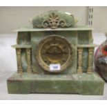 A mid 20thC onyx cased mantle clock of architectural form; the American movement faced by a Roman