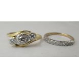 A 10ct gold and platinum three stone diamond ring; and a 9ct gold diamond set half eternity ring