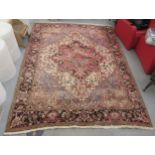 A Persian carpet, profusely decorated with floral and other stylised designs, on a multi-coloured