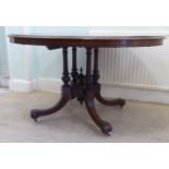 A late Victorian burr walnut table, the oval top raised on a four pillar support and a splayed