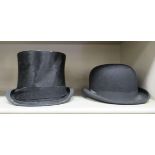 A silk top hat  22"dia inner circumference; and a Dunn & Co black bowler hat  22"dia inner