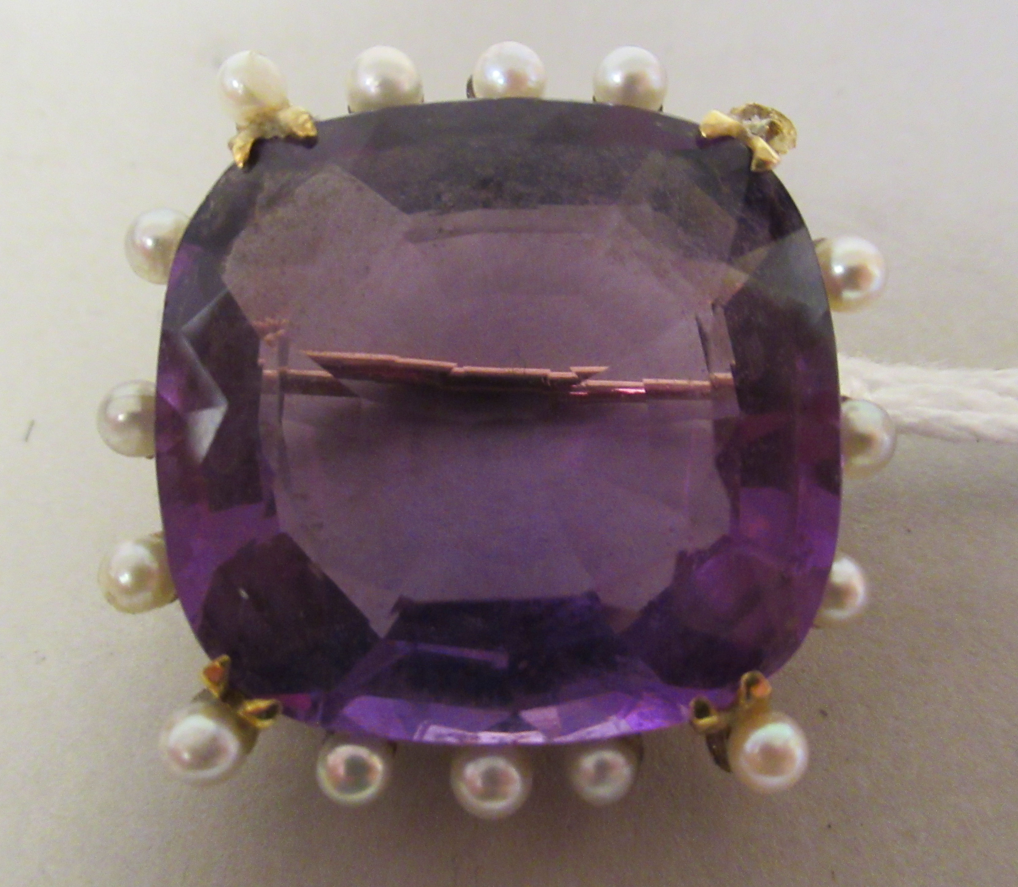 An 18ct gold amethyst and seed pearl set brooch (one pearl now missing)