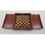 An early 20thC traveller's chess set, the folding mahogany box revealing a board and carved bone,