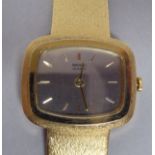 A lady's Seiko 18ct gold cased bracelet wristwatch, on a textured, flexible strap, faced by a
