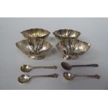 A set of four silver pedestal salts  London 1904; and four matched condiments spoons  mixed marks