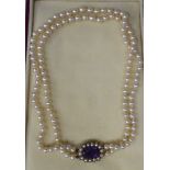 A double row pearl necklace, on an oval 9ct gold amethyst and pearl set bayonet clasp