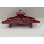 A late 19thC majolica floral decorated and damsen glazed earthenware inkstand, ornamented with a