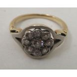 A bi-coloured metal ring, set with nine diamonds