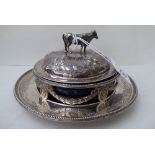 A late Victorian silver butter dish, the dome shaped lid, surmounted by a cow finials, the blue