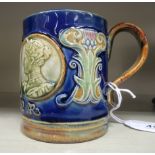 A Royal Doulton blue, green and brown stoneware mug, celebrating the Coronation of King Edward VII