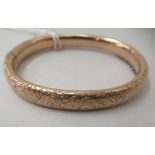 A 10ct gold hinged bangle