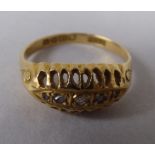 An 18ct gold ring, set with three diamond chips