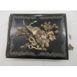 An early 20thC Japanese black lacquered and bone mounted photograph album with cut out card sleeves,