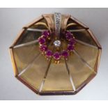 An Art Deco gold coloured metal fan shaped brooch, set with rubies and diamonds