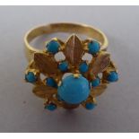 A yellow metal floral design ring, set with turquoise beads  stamped 720