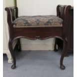 An Edwardian mahogany framed music stool with a hinged cushioned seat, raised on cabriole legs and